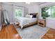 Stylish bedroom with a large window and hardwood flooring at 1514 Wensley Dr, Charlotte, NC 28210