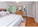 Bright bedroom with hardwood floors, large window and ensuite bathroom at 1514 Wensley Dr, Charlotte, NC 28210