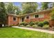 Charming brick home with a manicured lawn and lush landscaping at 1514 Wensley Dr, Charlotte, NC 28210