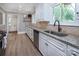 Well-lit kitchen with granite counters and a view from the window at 1514 Wensley Dr, Charlotte, NC 28210