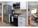 Updated kitchen features stainless steel appliances, granite countertops, and tile backsplash at 1514 Wensley Dr, Charlotte, NC 28210