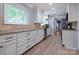 Bright kitchen with white cabinets and stainless steel appliances at 1514 Wensley Dr, Charlotte, NC 28210