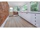 Spacious sunroom with brick accent wall and ample natural light at 1514 Wensley Dr, Charlotte, NC 28210