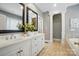 Elegant bathroom with double sinks, white cabinetry, and a soaking tub at 16216 Woolwine Rd, Charlotte, NC 28278