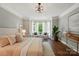 Bright and airy bedroom with large windows, hardwood floors, and a cozy sitting area at 16216 Woolwine Rd, Charlotte, NC 28278