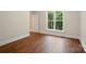 Bright bedroom featuring hardwood floors and a large window with natural light at 16216 Woolwine Rd, Charlotte, NC 28278
