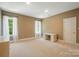 Bright bedroom with neutral carpet, multiple windows, and a desk at 16216 Woolwine Rd, Charlotte, NC 28278