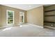 Bright bedroom with neutral carpet, multiple windows, and built-in shelving at 16216 Woolwine Rd, Charlotte, NC 28278