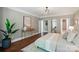 Bedroom featuring hardwood floors, stylish decor, and doorways to other rooms at 16216 Woolwine Rd, Charlotte, NC 28278