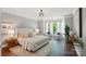 Inviting bedroom showcasing hardwood floors, and a cozy sitting area by large windows at 16216 Woolwine Rd, Charlotte, NC 28278