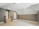 Finished bonus room featuring neutral carpet, gray and white paint scheme, and modern lighting at 16216 Woolwine Rd, Charlotte, NC 28278