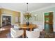 Well-lit dining area with a round table, stylish decor, and seamless flow to other spaces at 16216 Woolwine Rd, Charlotte, NC 28278