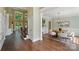 Open-concept space with a round dining table, wainscoting, and view to the front entry at 16216 Woolwine Rd, Charlotte, NC 28278