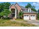 Stately brick home featuring an arched entry, two-car garage, and manicured lawn at 16216 Woolwine Rd, Charlotte, NC 28278