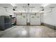 Two-car garage with overhead door and painted cement floors at 16216 Woolwine Rd, Charlotte, NC 28278