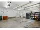 Spacious garage with storage shelving, multiple doors, and concrete floors at 16216 Woolwine Rd, Charlotte, NC 28278