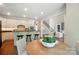 Bright kitchen features an island with seating and a view to the living room and dining nook at 16216 Woolwine Rd, Charlotte, NC 28278