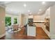 Modern kitchen with white cabinets, black countertops, stainless steel appliances, and adjacent dining area at 16216 Woolwine Rd, Charlotte, NC 28278