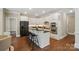 Beautiful kitchen featuring a center island with seating, white cabinets, and stainless steel appliances at 16216 Woolwine Rd, Charlotte, NC 28278