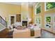 Bright living room features a fireplace, soaring windows, and easy access to the outdoor deck at 16216 Woolwine Rd, Charlotte, NC 28278