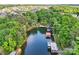 Aerial view of lake showcasing multiple boat slips, surrounded by lush greenery and neighborhood at 16427 Cozy Cove Rd, Charlotte, NC 28278