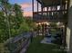 Inviting outdoor living space with an upper deck, seating area and lush greenery at 16427 Cozy Cove Rd, Charlotte, NC 28278