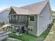 Back of the home with a screened in porch, patio seating area and well-manicured backyard at 16427 Cozy Cove Rd, Charlotte, NC 28278