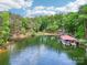 Beautiful lake view featuring covered boat slips nestled among lush trees and crystal water at 16427 Cozy Cove Rd, Charlotte, NC 28278