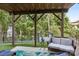 Cozy patio with comfortable seating, an overhead fan, and a view of the lake surrounded by green trees at 16427 Cozy Cove Rd, Charlotte, NC 28278