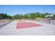 Outdoor pickleball court under a clear blue sky, surrounded by green trees, perfect for community recreation at 16427 Cozy Cove Rd, Charlotte, NC 28278