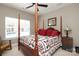 Traditional bedroom showcasing a four-poster bed, a ceiling fan, and neutral wall paint at 2114 N Castle Ct, Matthews, NC 28105
