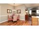 Cozy dining area featuring wood floors and stylish red patterned chairs around a glass table at 2114 N Castle Ct, Matthews, NC 28105