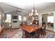 Open concept: Dining area flows to living room with hardwood floors and neutral color palette at 2114 N Castle Ct, Matthews, NC 28105