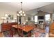 Dining area features a chandelier, wood table, and an open floor plan at 2114 N Castle Ct, Matthews, NC 28105