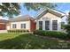 Beautiful home with well-maintained lawn and manicured hedges beneath large windows at 2114 N Castle Ct, Matthews, NC 28105