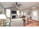Inviting living room with fireplace, hardwood floors, and open floor plan flowing to sunroom at 2114 N Castle Ct, Matthews, NC 28105