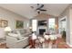 Bright living room features vaulted ceiling, fireplace, hardwood floors, and a ceiling fan at 2114 N Castle Ct, Matthews, NC 28105