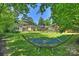 Expansive backyard featuring a hammock, mature trees, and a lush green lawn, creating a peaceful oasis at 2115 Mecklenburg Ave, Charlotte, NC 28205
