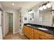 Bathroom featuring double vanities with granite countertops, tile floor, and a linen closet at 2115 Mecklenburg Ave, Charlotte, NC 28205