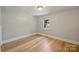 Bedroom featuring hardwood floors, a window, and neutral paint at 2115 Mecklenburg Ave, Charlotte, NC 28205
