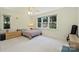 Bedroom with a large window offering backyard views, light carpet, and a ceiling fan at 2115 Mecklenburg Ave, Charlotte, NC 28205