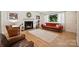 Cozy living room featuring a fireplace, comfortable seating, and a bright window at 2115 Mecklenburg Ave, Charlotte, NC 28205