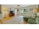 Open living space with hardwood floors, a comfortable green sectional, and lots of natural light at 2115 Mecklenburg Ave, Charlotte, NC 28205