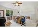 Bright room with a desk and a chair and windows overlooking a treed yard, with white carpet at 2115 Mecklenburg Ave, Charlotte, NC 28205