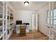 Bright home office with built-in shelving and French doors, showcasing a functional workspace at 2115 Mecklenburg Ave, Charlotte, NC 28205