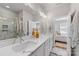 Elegant bathroom featuring double sinks, sleek countertops, a glass-enclosed shower, and upscale finishes at 2123 Bryant Park Dr, Charlotte, NC 28208