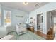 Bright Bedroom with white crib, desk, and decor, featuring hardwood floors and an attached bathroom at 2123 Bryant Park Dr, Charlotte, NC 28208