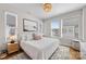 Inviting bedroom with plush bedding, stylish chandelier, and lots of natural light for a relaxing and airy atmosphere at 2123 Bryant Park Dr, Charlotte, NC 28208