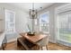 Bright dining area with a wood table, bench seating, and natural light at 2123 Bryant Park Dr, Charlotte, NC 28208