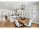 Dining area with view to kitchen, modern light fixture, and hardwood floors at 2123 Bryant Park Dr, Charlotte, NC 28208